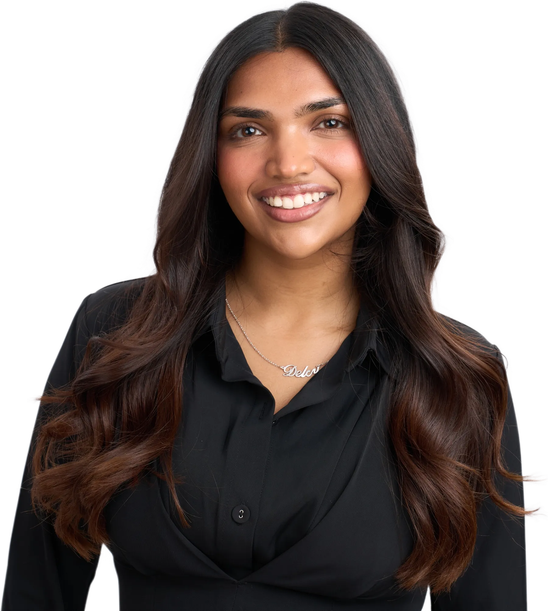 Delcy Pandya in a black shirt, smiling, with long dark hair and a necklace that spells Delcy